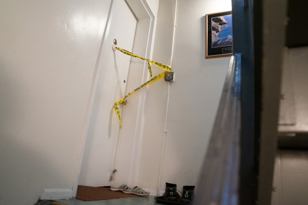 Police tape is pictured after Bryan Wong was found dead on a pullout couch inside the living room of their single-family home on 59th St. near Laurel Hill Blvd. in Woodside, Queens, on Wednesday, Oct. 14, 2026. (Barry Williams / New York Daily News)