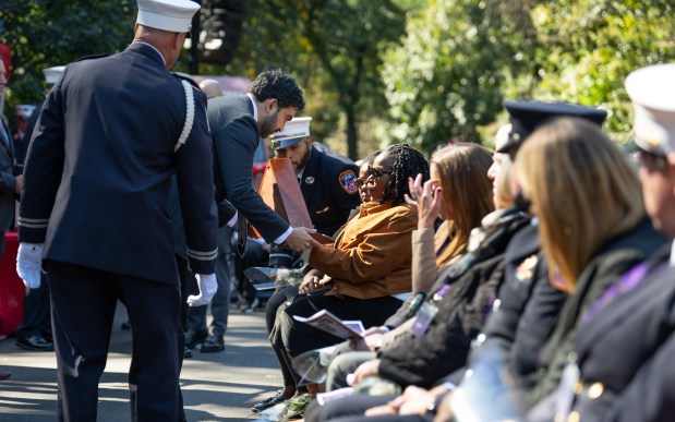 Mayor Zohran Mamdani presents the widow of FDNY Paramedic Salih A. Abdur-Rahman, Nura Abdul-Karim with the FDNY department flag at the Fireman's Monument during the FDNY Annual Memorial Service Wednesday, October, 7, 2026 in Manhattan, New York. (Barry Williams/ New York Daily News)