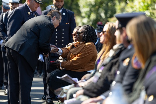 FDNY Commissioner Lillian Bonsignore presents the widow of FDNY Paramedic Salih A. Abdur-Rahman, Nura Abdul-Karim with the Medal of Valor during the Fireman's Monument during the FDNY Annual Memorial Service Wednesday, October, 7, 2026 in Manhattan, New York. (Barry Williams/ New York Daily News)
