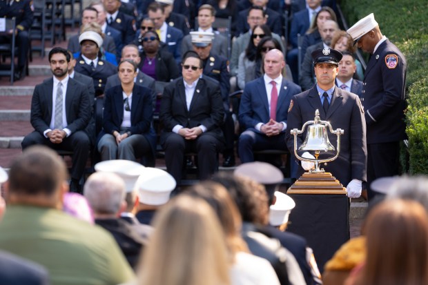 A FDNY firefighter rings a bell for FDNY members who have died this past year during the FDNY Annual Memorial Service at the Fireman's Monument Wednesday, October, 7, 2026 in Manhattan, New York. (Barry Williams/ New York Daily News)