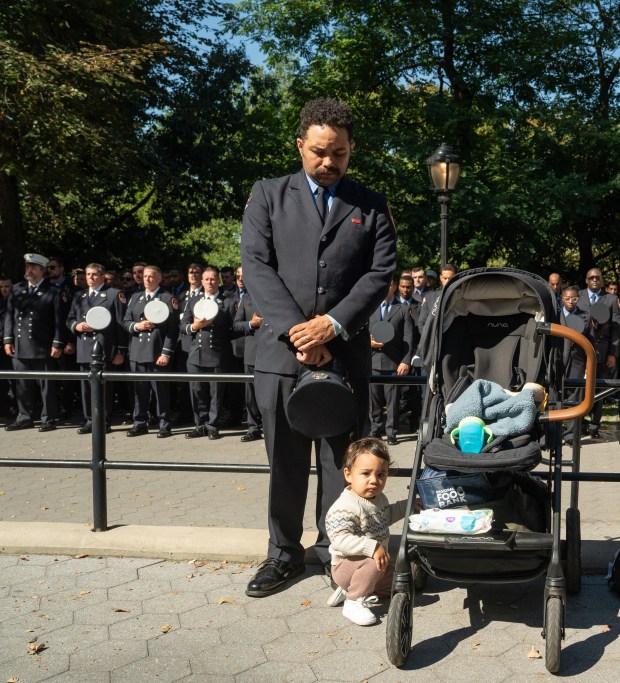 A FDNY members bows his head in respect during the FDNY Annual Memorial Service at the Fireman's Monument Wednesday, October, 7, 2026 in Manhattan, New York. (Barry Williams/ New York Daily News)