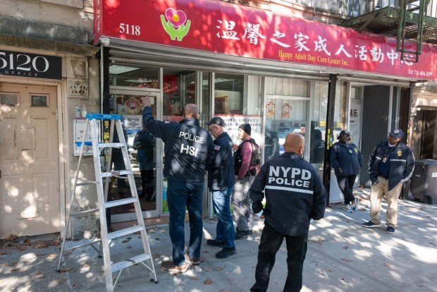 Federal agents conduct a raid at an adult day care center at 5118 Fort Hamilton Parkway in Brooklyn on Tuesday. 