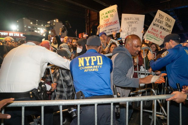 Protestors struggle for control of barricades with NYPD officers outside New York- Presbyterian Allen Hospital after ICE agents shot and wounded a man on Marble Hill Ave. near W. 225th St. on Thursday, Oct. 8, 2026 in the Bronx. (Barry Williams/ New York Daily News)