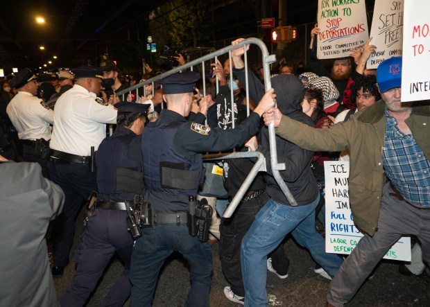 Protestors struggle for control of barricades with NYPD officers outside New York- Presbyterian Allen Hospital after ICE agents shot and wounded a man on Marble Hill Ave. near W. 225th St. on Thursday, Oct. 8, 2026 in the Bronx. (Barry Williams/ New York Daily News)