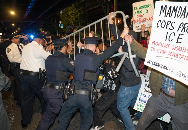 Protestors struggle for control of barricades with NYPD officers outside New York- Presbyterian Allen Hospital after ICE agents shot and wounded a man on Marble Hill Ave. near W. 225th St. on Thursday, Oct. 8, 2026 in the Bronx. (Barry Williams/ New York Daily News)