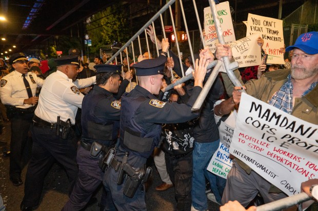 Protestors struggle for control of barricades with NYPD officers outside New York- Presbyterian Allen Hospital after ICE agents shot and wounded a man on Marble Hill Ave. near W. 225th St. on Thursday, Oct. 8, 2026 in the Bronx. (Barry Williams/ New York Daily News)