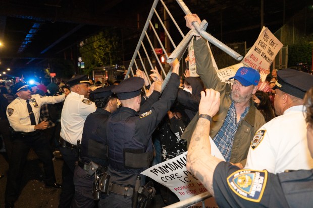 Protestors struggle for control of barricades with NYPD officers outside New York- Presbyterian Allen Hospital after ICE agents shot and wounded a man on Marble Hill Ave. near W. 225th St. on Thursday, Oct. 8, 2026 in the Bronx. (Barry Williams/ New York Daily News)