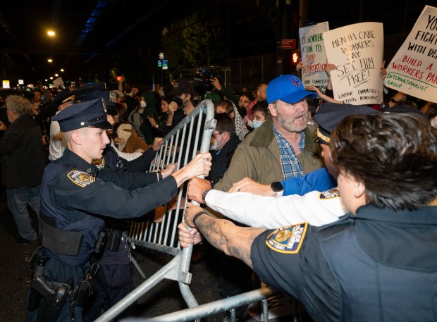 Protestors struggle for control of barricades with NYPD officers outside New York- Presbyterian Allen Hospital after ICE agents shot and wounded a man on Marble Hill Ave. near W. 225th St. on Thursday, Oct. 8, 2026 in the Bronx. (Barry Williams/ New York Daily News)