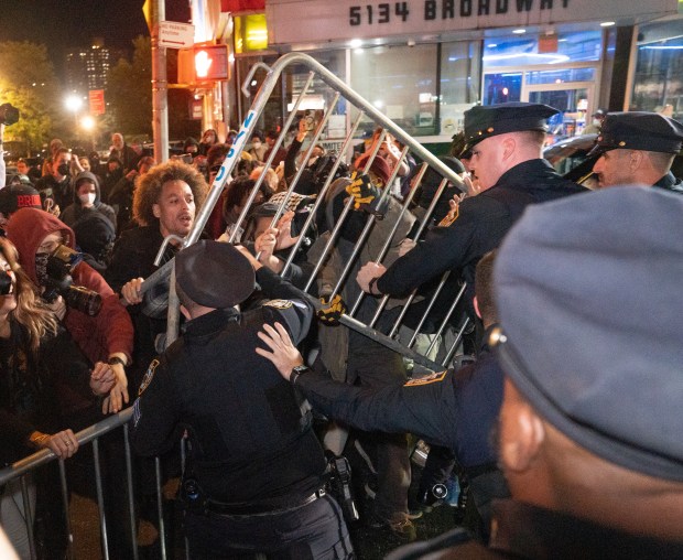 Protestors struggle for control of barricades with NYPD officers outside New York- Presbyterian Allen Hospital after ICE agents shot and wounded a man on Marble Hill Ave. near W. 225th St. on Thursday, Oct. 8, 2026 in the Bronx. (Barry Williams/ New York Daily News)