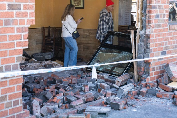 A parking mishap led a woman to plow her white BMW into a Queens pizzeria, injuring herself and a man dining at the New Park Pizza, on Cross Bay Blvd. near 157th Ave. in Howard Beach on Thursday, Oct. 15, 2026. (Theodore Parisienne / New York Daily News)