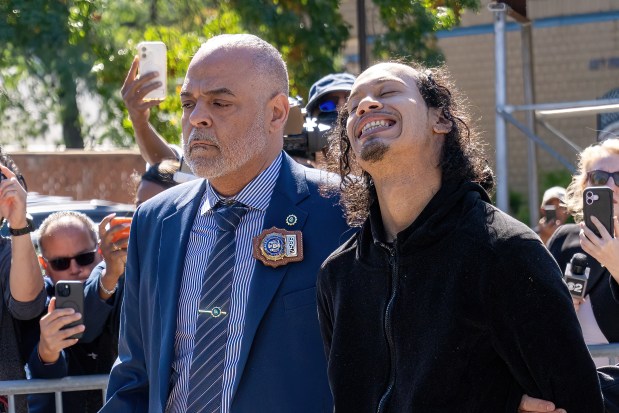 Angel Carrasco (right), the suspect in the murder of Nathaly Ramirez and attempted murder of her eight-month-old daughter, is pictured in police custody leaving the NYPD's 49th Precinct stationhouse in the Bronx on Thursday, Oct. 8, 2026. (Theodore Parisienne / New York Daily News)