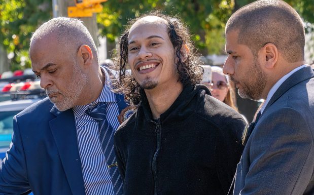 Angel Carrasco (center), the suspect in the murder of Nathaly Ramirez and attempted murder of her eight-month-old daughter, is pictured in police custody leaving the NYPD's 49th Precinct stationhouse in the Bronx on Thursday, Oct. 8, 2026. (Theodore Parisienne / New York Daily News)