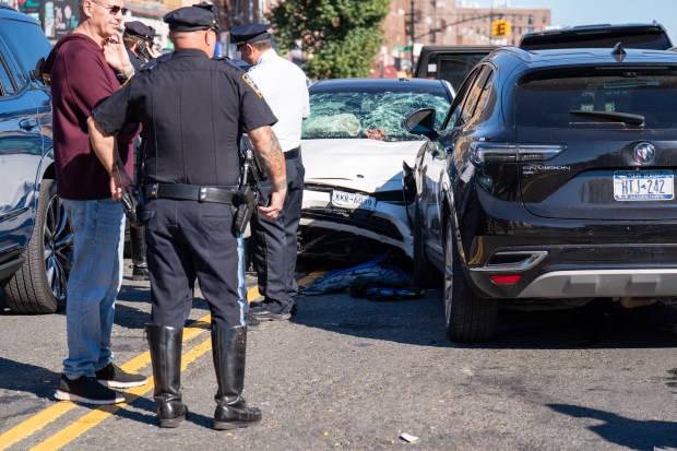 Police investigate after a white Mercedes struck three pedestrians, killing two, on Allerton Ave. in the Bronx on Friday.