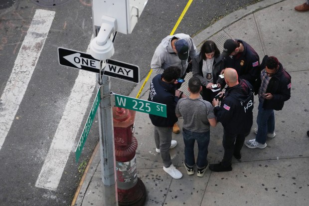 Law enforcement officers investigate after ICE agents shot and wounded a man on Marble Hill Ave. near W. 225th St. in the Bronx on Thursday, Oct. 8, 2026. (Barry Williams / New York Daily News)