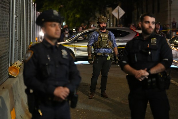 Law enforcement officers investigate after ICE agents shot and wounded a man on Marble Hill Ave. near W. 225th St. in the Bronx on Thursday, Oct. 8, 2026. (Barry Williams / New York Daily News)