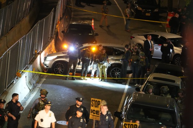 Law enforcement officers investigate after ICE agents shot and wounded a man on Marble Hill Ave. near W. 225th St. in the Bronx on Thursday, Oct. 8, 2026. (Barry Williams / New York Daily News)