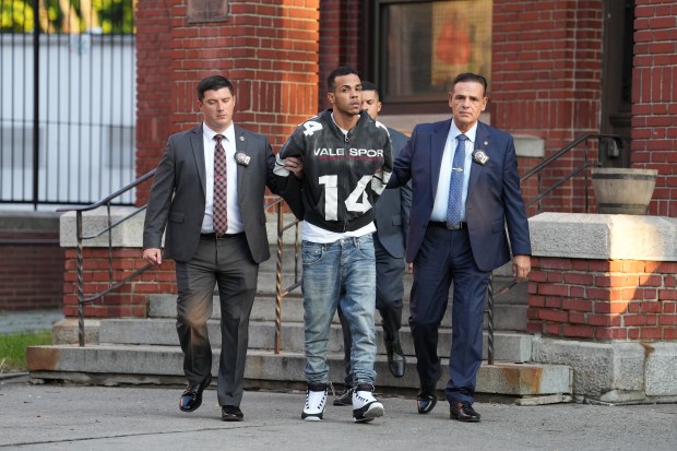 Sneider Mejia (center) is pictured in police custody leaving the NYPD's 52nd Precinct stationhouse in the Bronx on Tuesday, Oct. 13, 2026. (Barry Williams / New York Daily News)
