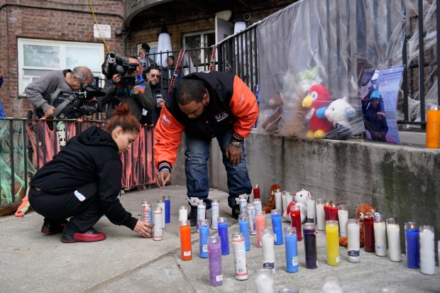 Mourners are pictured after a deadly lithium-ion battery fire caused by an e-bike in an 11th-floor apartment in the Patterson Houses on Morris Ave. near E. 140th St. in the Bronx early Wednesday, Oct. 28, 2026. (Barry Williams / New York Daily News)