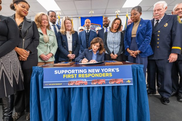 October 17, 2026 - Hempstead, NY - Governor Kathy Hochul signs legislation  quadrupling New York State Tax Credit for Volunteer Firefighters and Ambulance workers  and presents a check of 1 million dollars to Hempstead Fire Department for new radios (Darren McGee/Office of Governor Kathy Hochul)