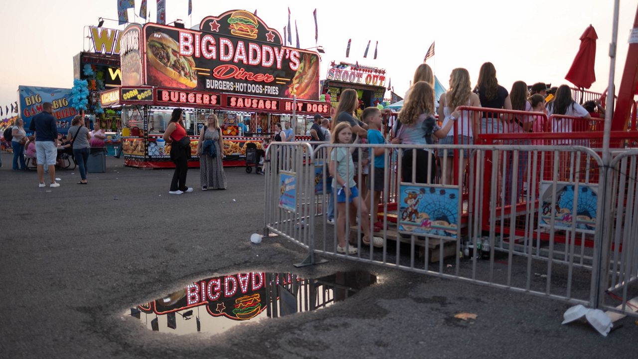 Fairgoers wait in line at the New York State Fair.