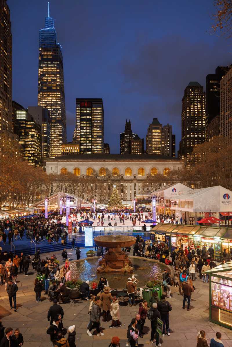 The Rink as the sun sets at Bank of America Winter Village at Bryant Park in NYC.