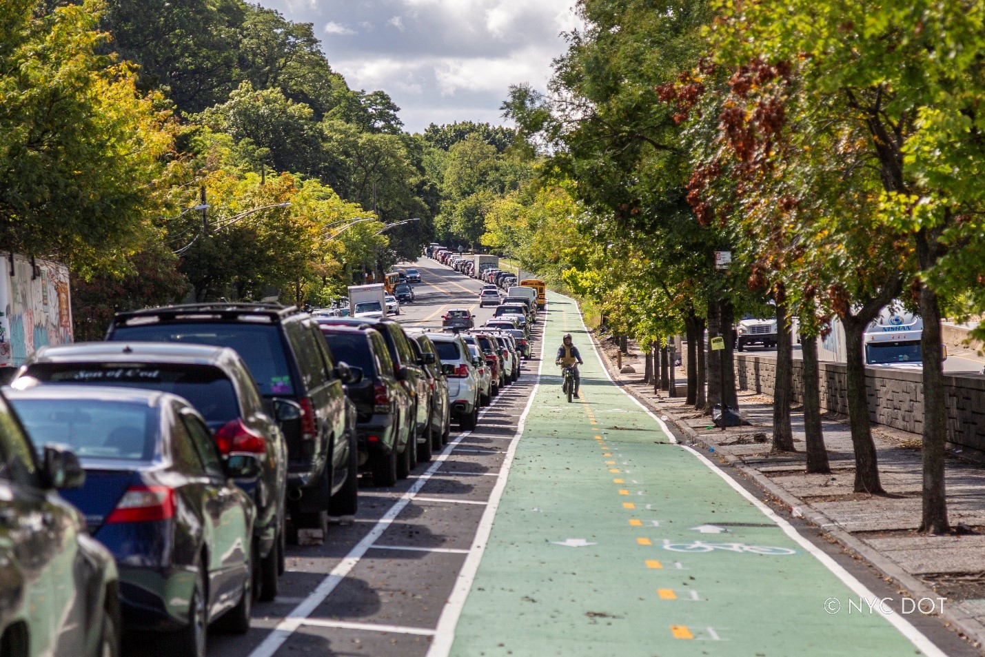 A cyclist rides in the parking-protected bike lane on Bailey Avenue in the Bronx. Credit: NYC DOT 