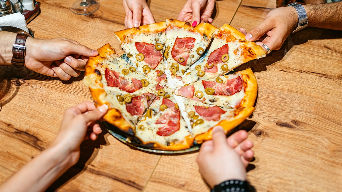 Friends sharing pizza