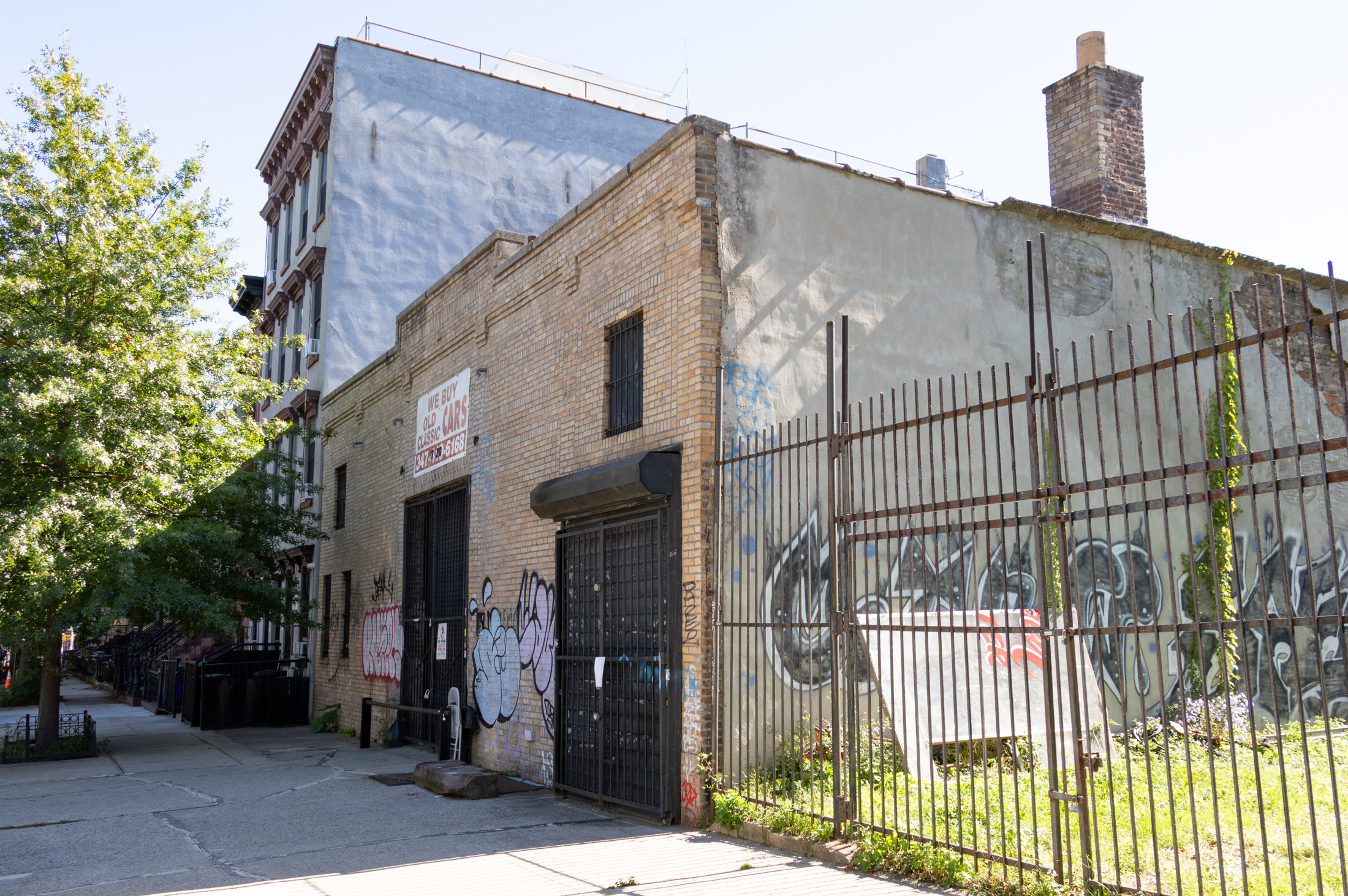 a brick garage and vacant lot