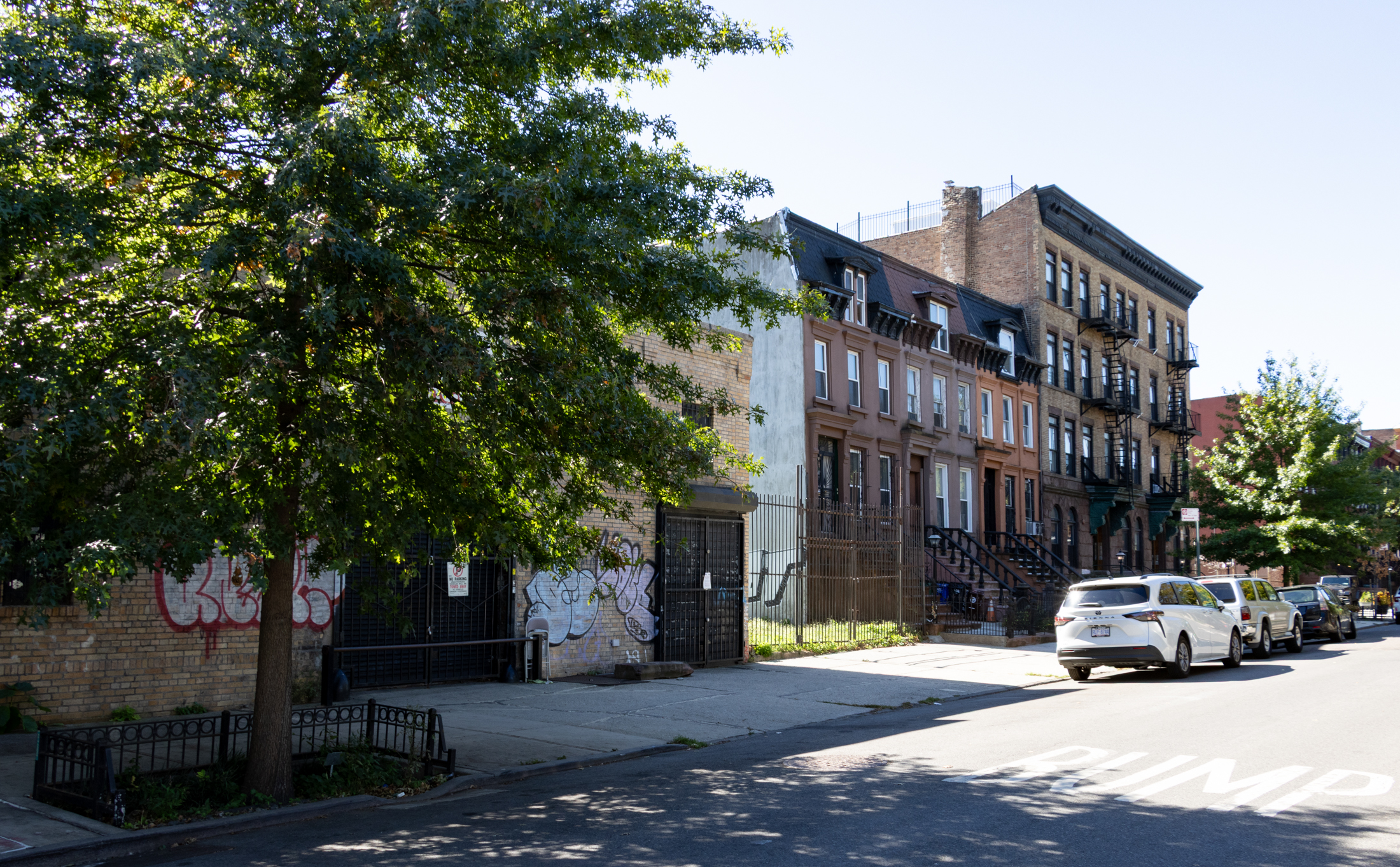 street view of macdonough street showing rowhouses enjoying an empty lot