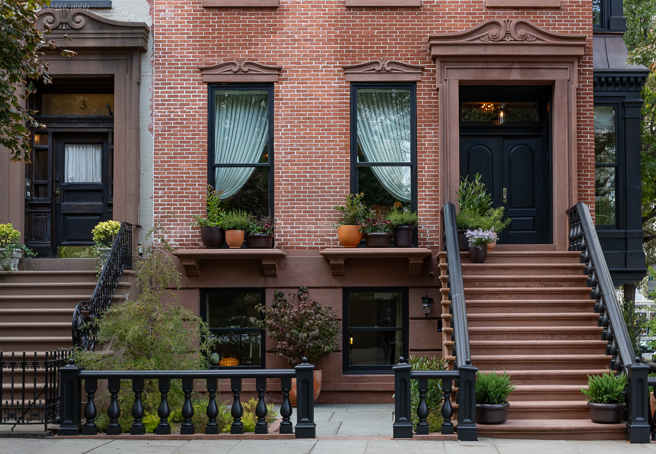 front of a row house with planters on the window sills