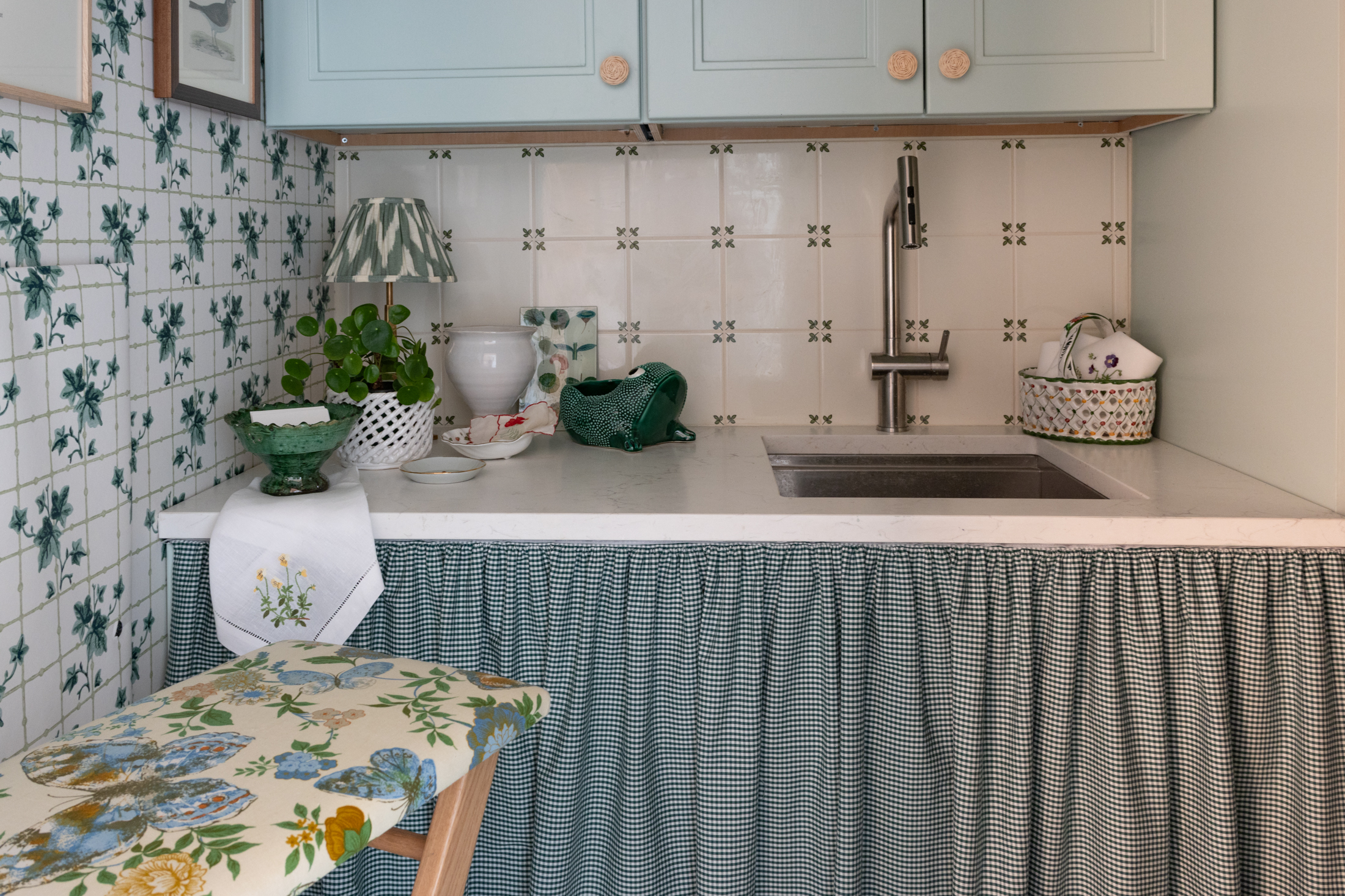 LAUNDRY ROOM - gingham skirt on cabinets and a tiny ironing board