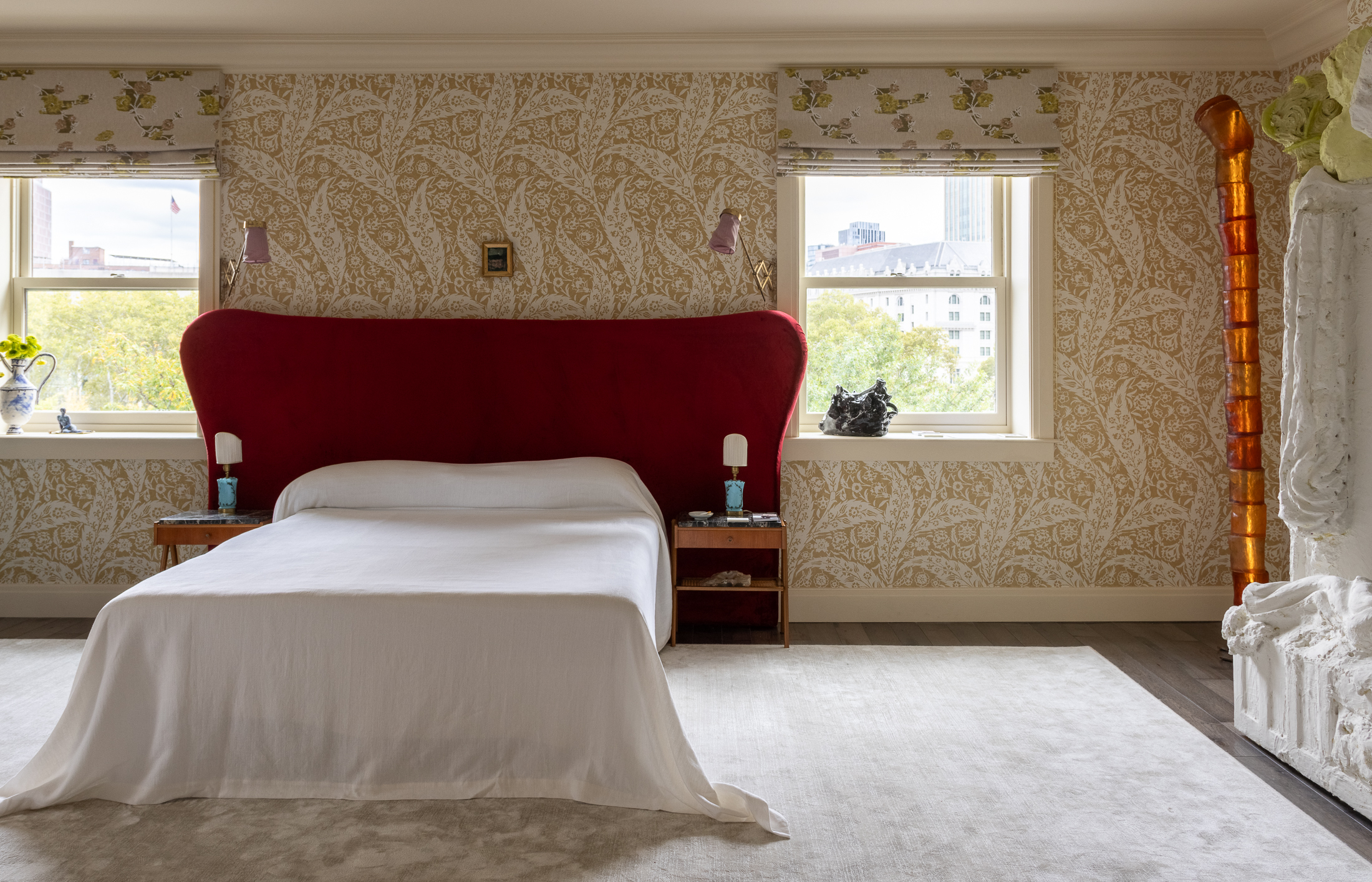 MAIN BEDROOM - neutral floral wallpaper and a red headboard