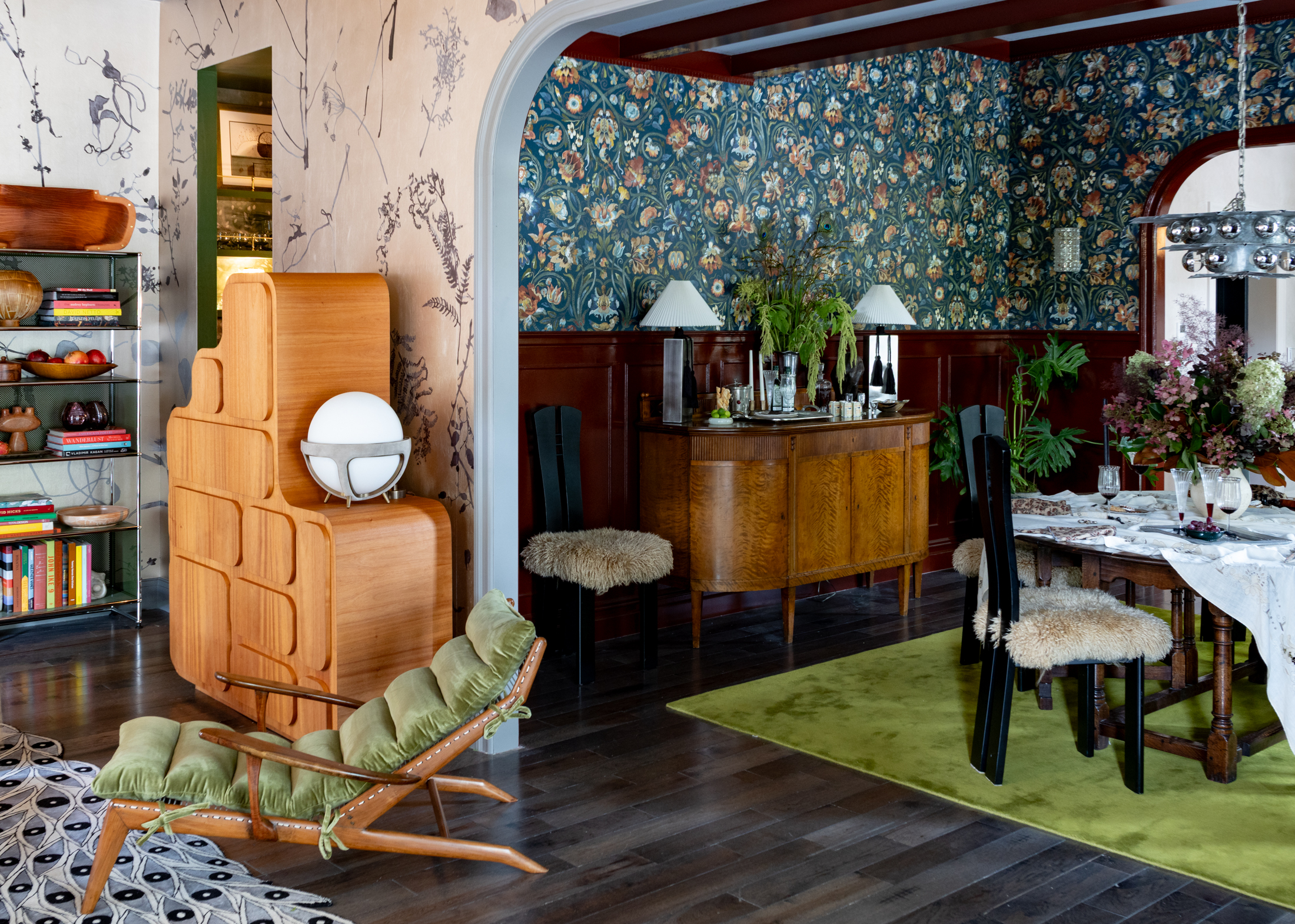 PARLOR AND DINING - a dining room with flowered wallpaper and deep red wainscoting
