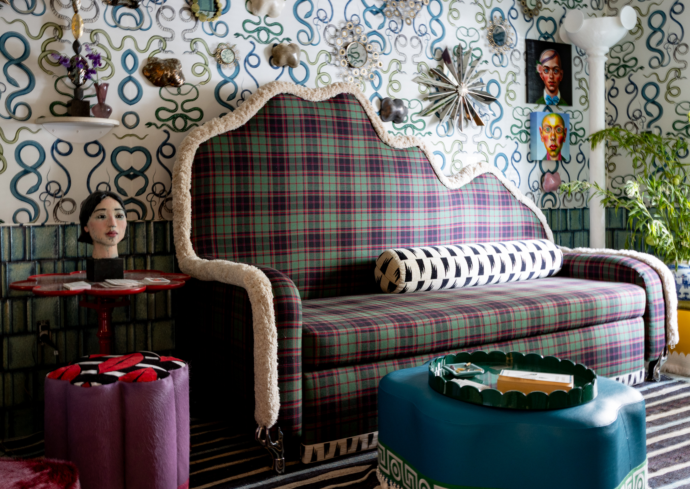 LOUNGE with plaid covered seating and snake covered walls
