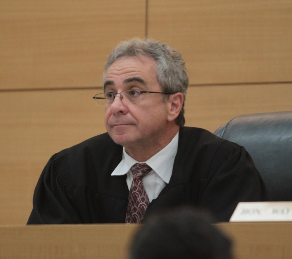 Brooklyn Supreme Court Judge Wayne Ozzi wearing a judicial robe and glasses.
