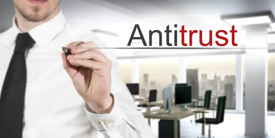 person in button-up and black tie in office underlining "antitrust" in air; Manhattan DA Announces Corporate Crime and Antitrust Task Force