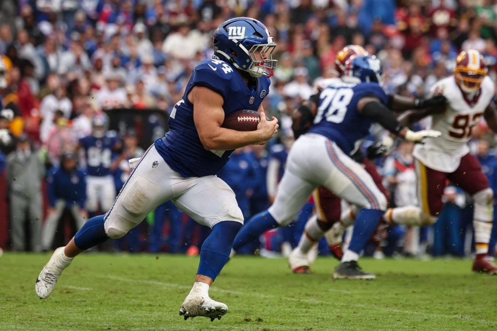 Giants' Cam Skattebo (44) carries the ball against the Washington Commanders during overtime in an NFL football game at Northwest Stadium in Landover, Maryland, Sunday, Oct. 11, 2026.