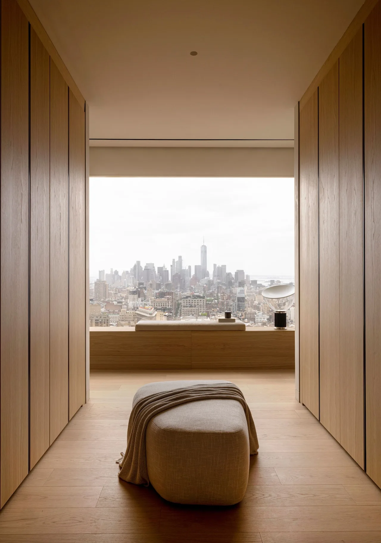 Relaxation nook by the window with a cozy chair and soft throw blanket.