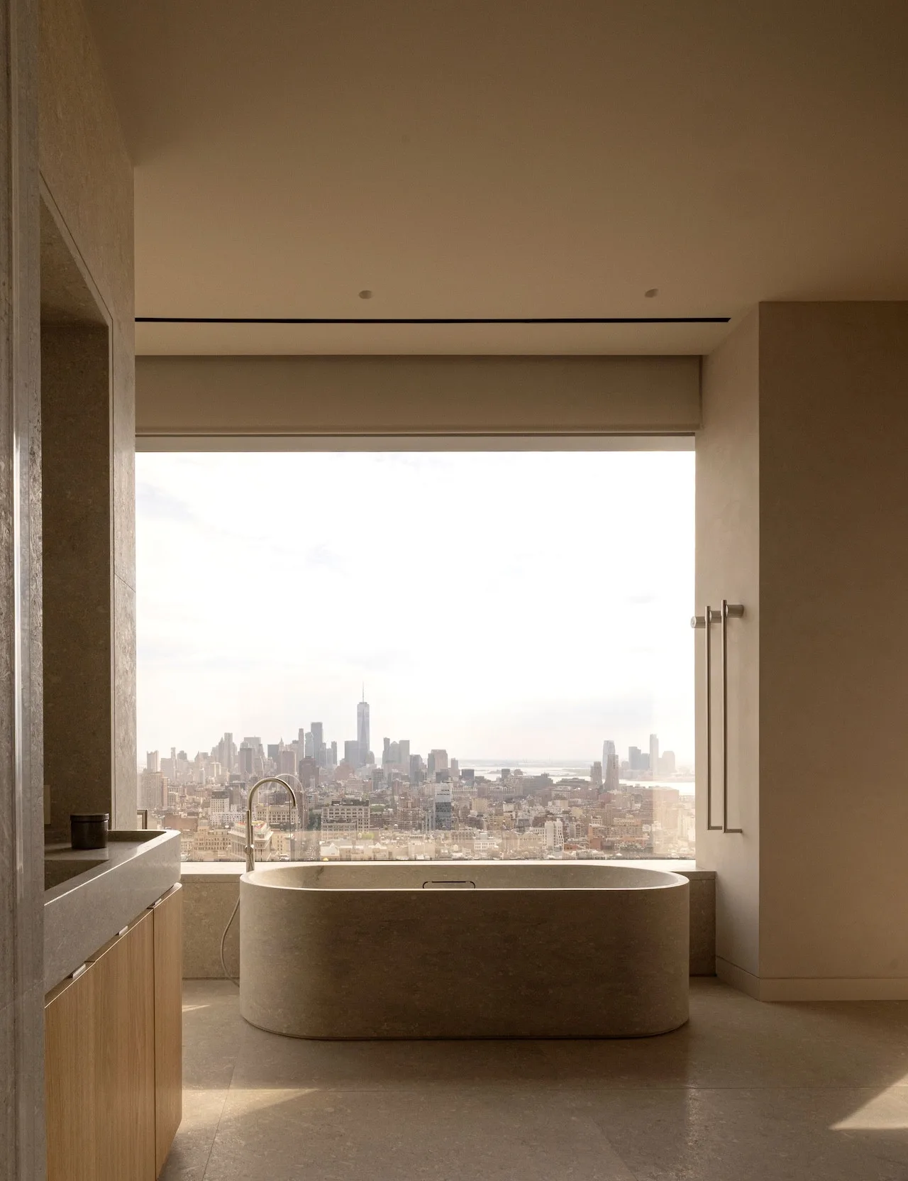 Cozy lounge area with plush seating and a view of city skyscrapers.
