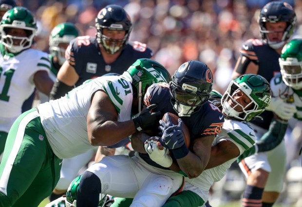 Bears running back D'Andre Swift is tackled by the Jets Jowon Briggs (91) and others during the first quarter of their game on Oct. 4, 2026, at Soldier Field in Chicago. (Brian Cassella/Chicago Tribune)