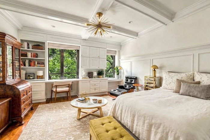 As seen in this listing photo, this studio in Carnegie Hill has moldings galore that nicely set off the many, many built-ins.