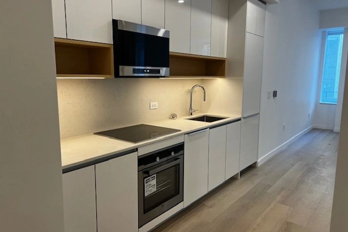 A lottery unit at 25 Water Street, seen in this listing photo, seems at least in some ways comparable to what you’d find in a market-rate apartment with new appliances and shiny lacquered cabinetry.