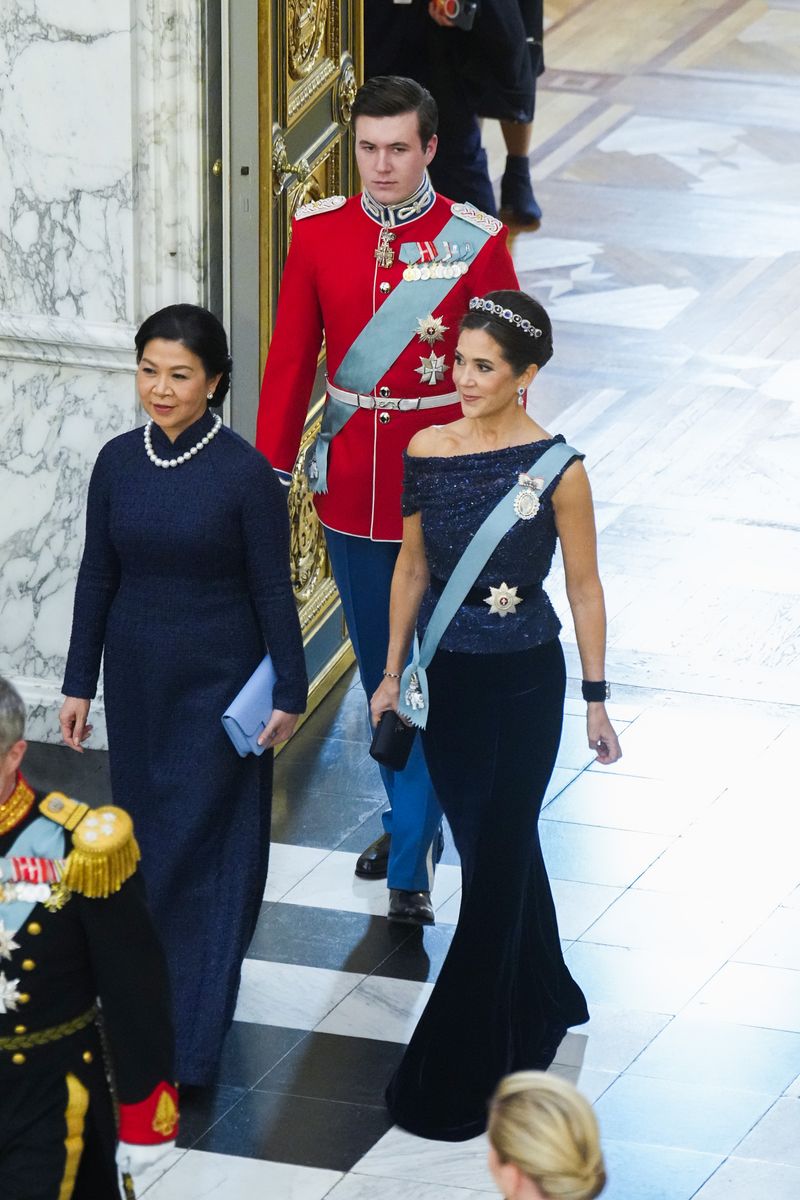 Queen Mary dazzled in a midnight-blue off-the-shoulder gown and a sparkling sapphire-and-diamond tiara during a state banquet at Christiansborg Palace.