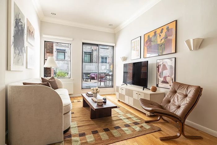 As seen in this listing photo, this Greenwich Village one-bedroom feels more spacious thanks to the enormous terrace just outside the living room.