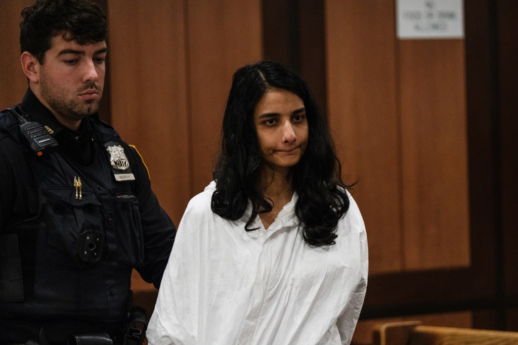 Francis Cabello is escorted by a police officer in court.