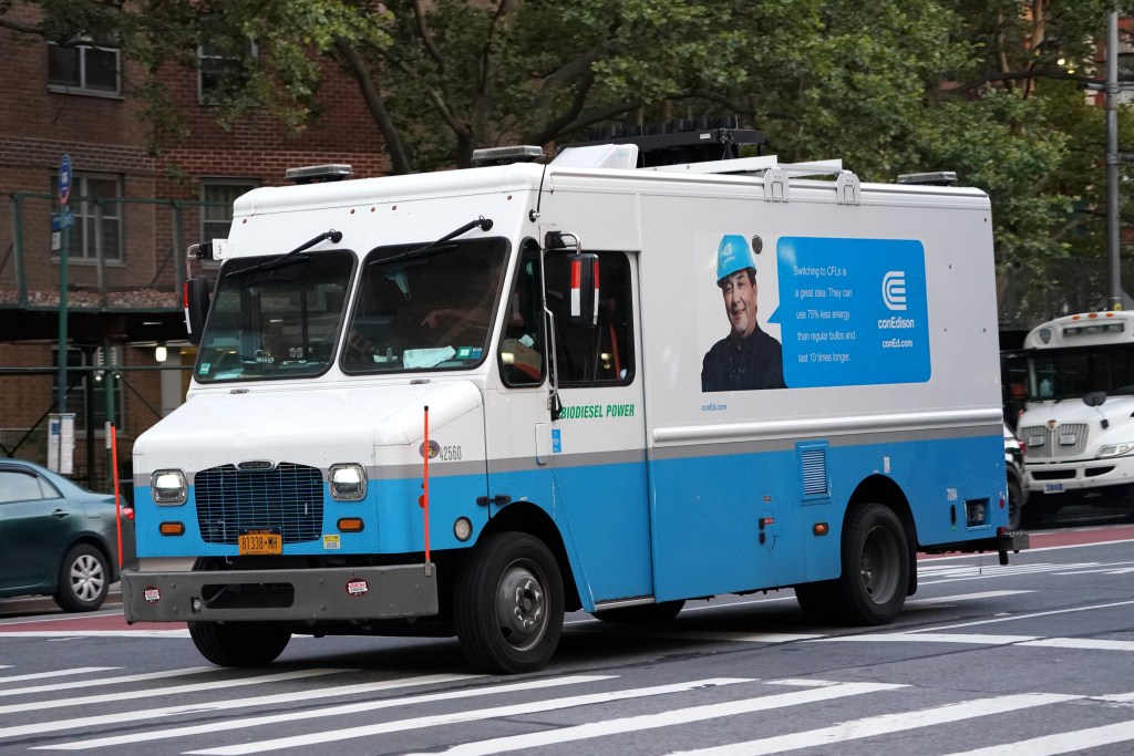 A Con Edison truck driving on a New York street.