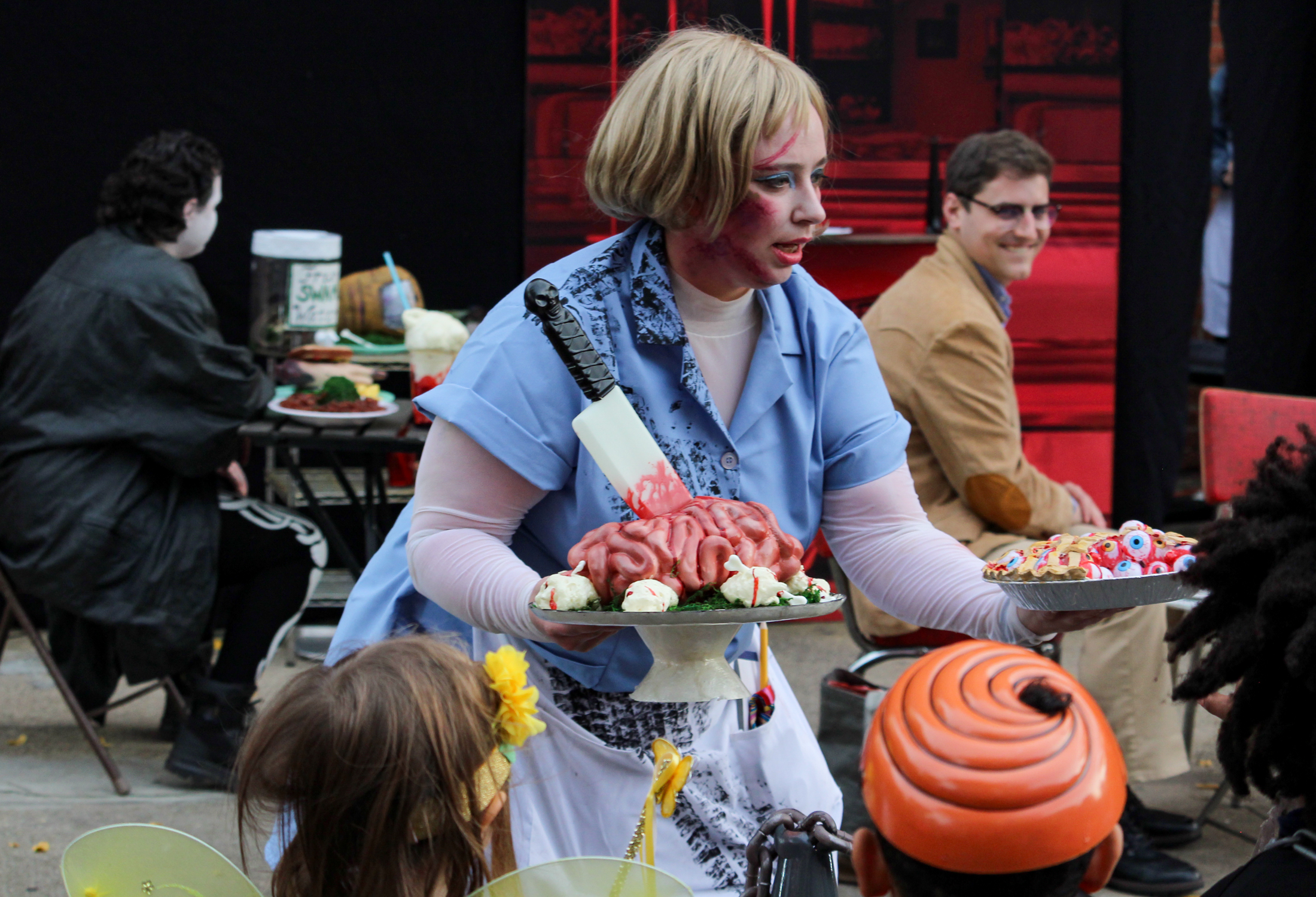 halloween - costumed actor holding fake food