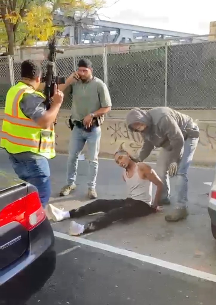 Federal agents stand near Oscar Belgal after he was shot during an encounter in the Marble Hill section of the Bronx, New York.