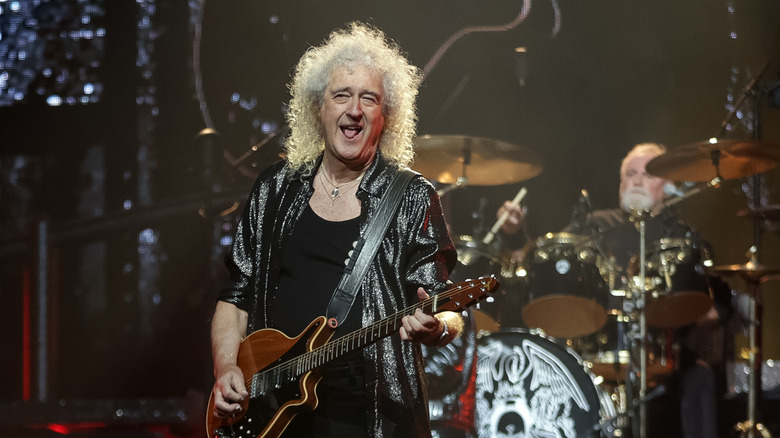 Queen's Brian May playing guitar onstage