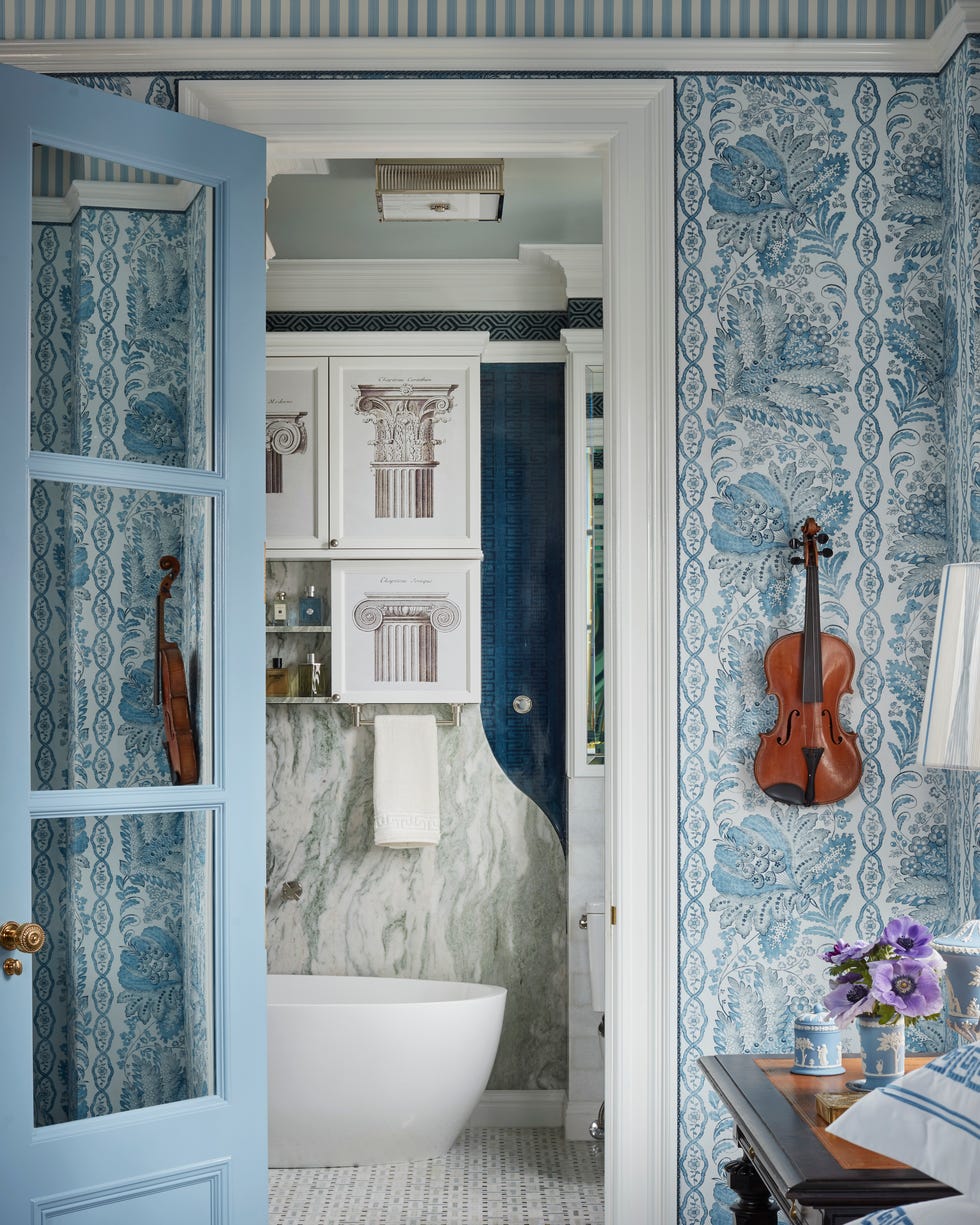 Marshall Watson New York Apartment Bathroom bathroom with blue and white wallpaper and a white freestanding tub